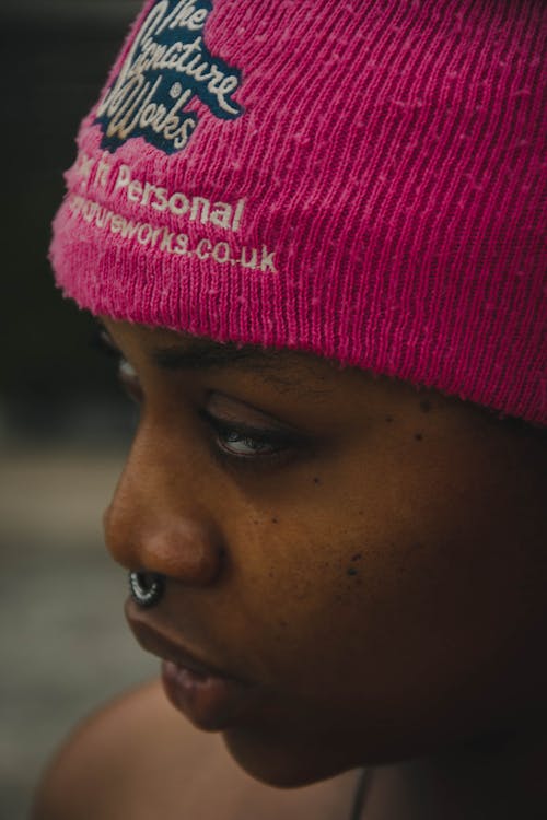 A Woman in Pink Beanie Looking Afar