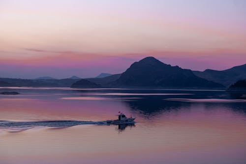 Motorboat on Lake at Dusk