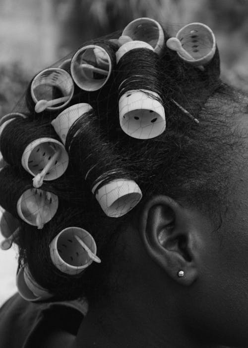 A Woman Using Hair Rollers on Her Har