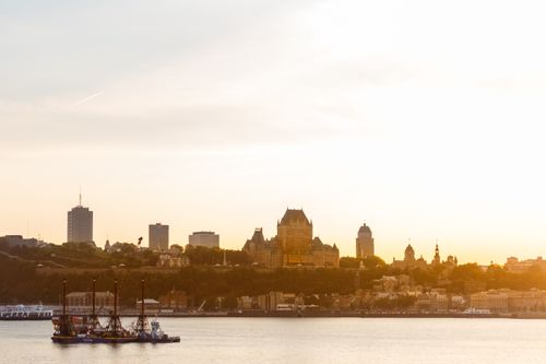 Free Scenic view of Québec City skyline at sunset featuring Château Frontenac and St. Lawrence River. Stock Photo