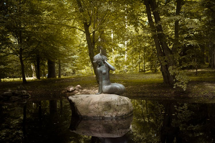 Rusalka Sculpture On Rock In Park