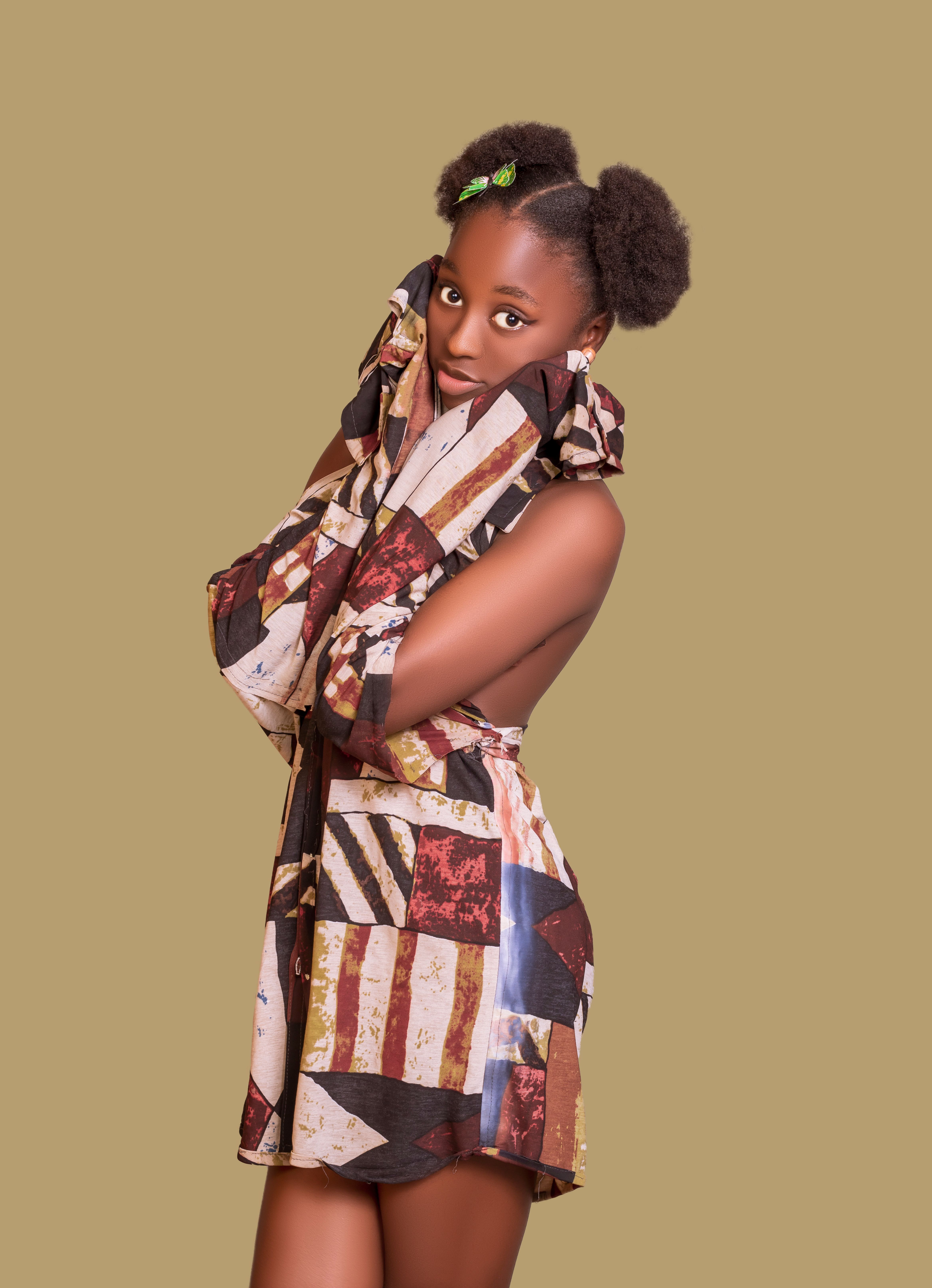 Stylish portrait of a young African American girl in vibrant attire.