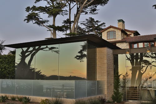Photo of a Seaside House with a Sunset Reflecting in the Glass