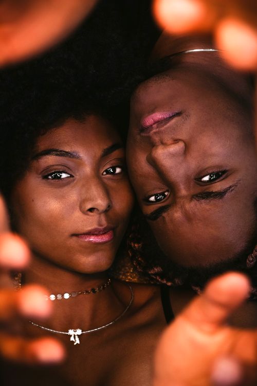 Free Intimate close-up portrait of two black women sharing a moment in Brazil, captured in warm tones. Stock Photo