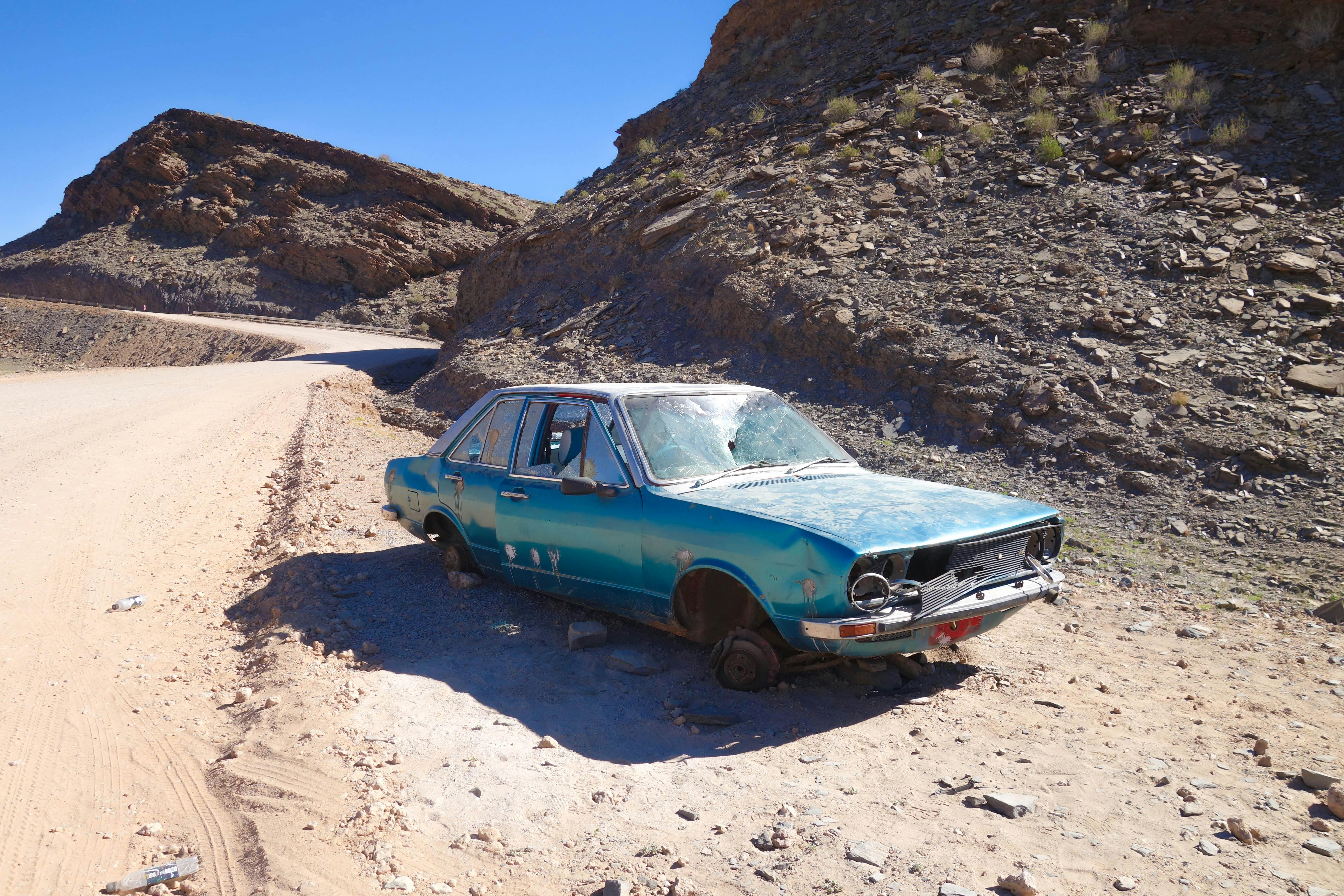 a blue car wreck on desert