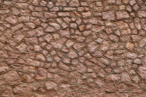 Photo of a Wall Made of Reddish Stones