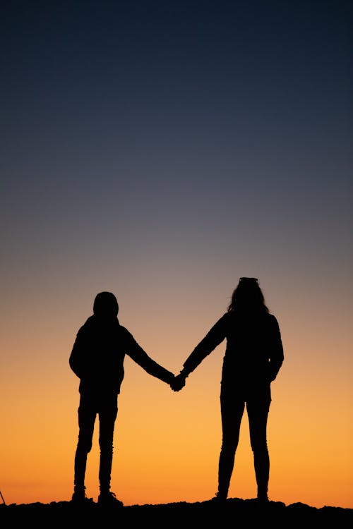 Silhouette of Couple Holding Hands
