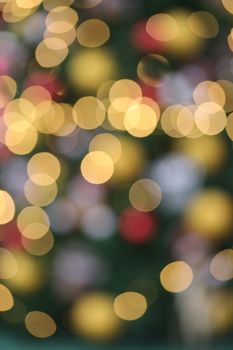 Colorful bokeh effect with blurred gold and red lights creates a festive ambiance.