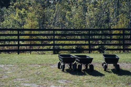 Photo of Three Black Garden Carts on the Grass