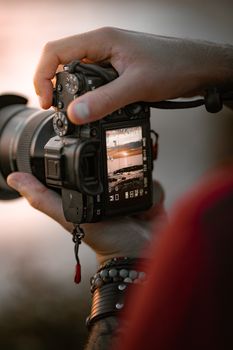 Close-up of a DSLR camera capturing a stunning sunset, showcasing photography skills at La Baule-Escoublac, France.