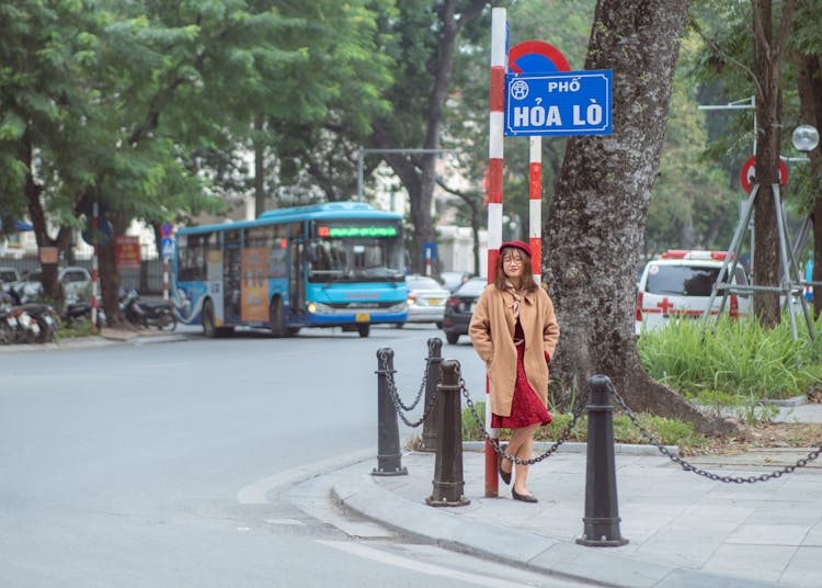 Woman Walking On A Sidewalk In A City In Vietnam 