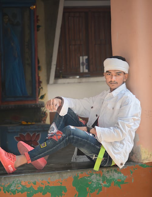 A Man in White Long Sleeves and Denim Jeans