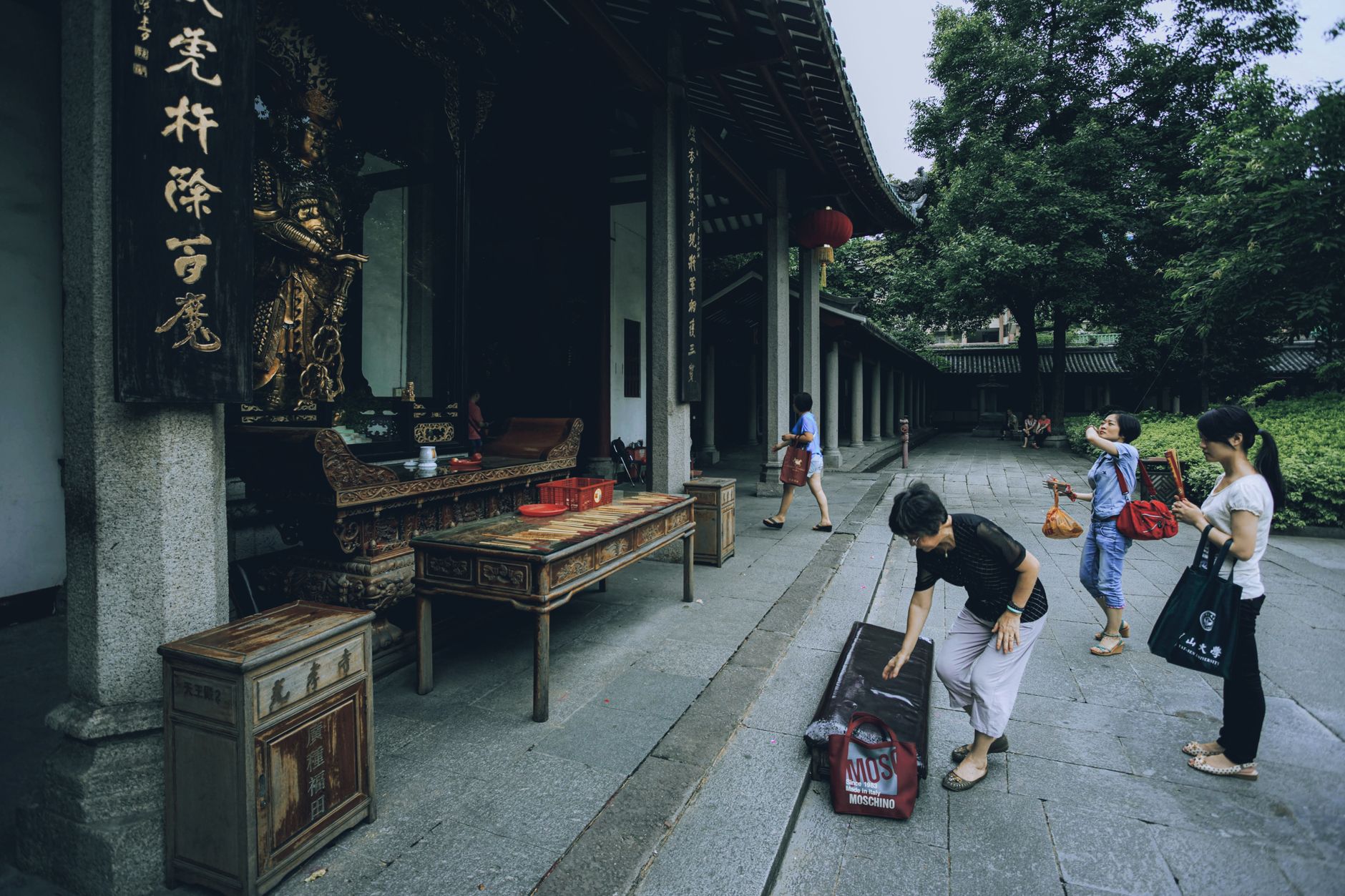Visitors explore a traditional Chinese temple, showcasing cultural architecture and spirituality.