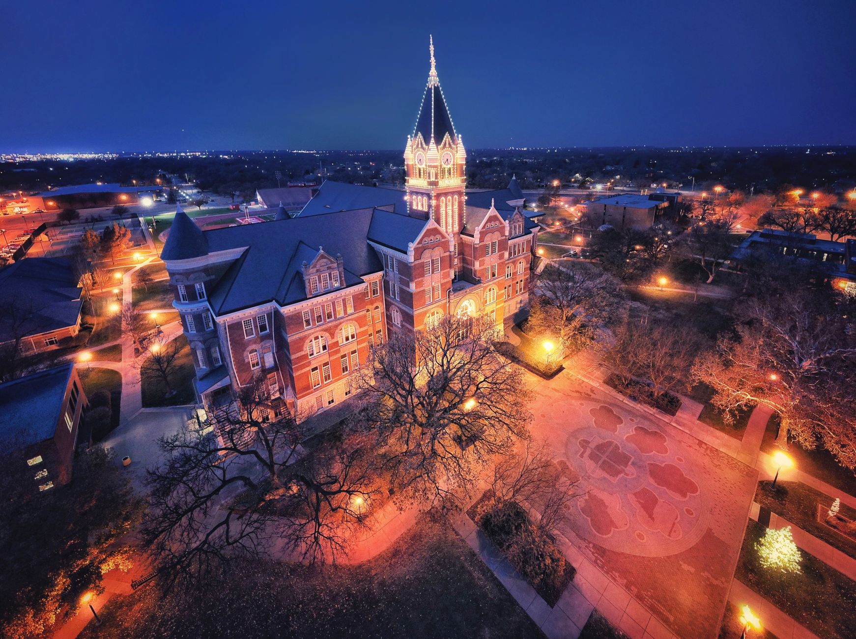 Stunning aerial night view of an illuminated university tower in Wichita, Kansas.