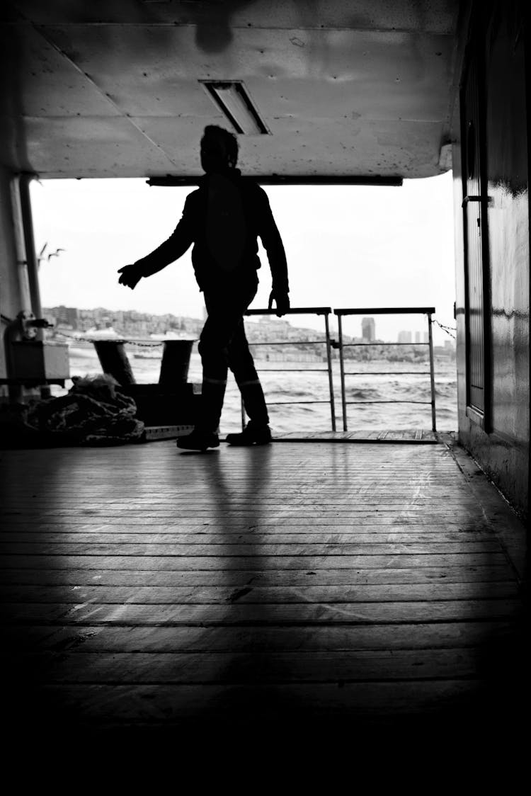 Man Walking On Wooden Floor In Black And White