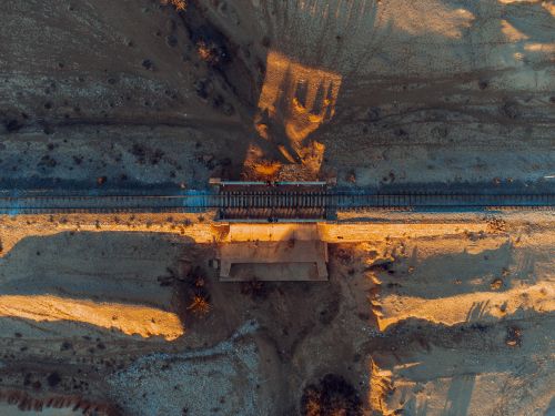 Free Drone photo of railway over arid landscape in Texas City, perfect for travel and nature themes. Stock Photo