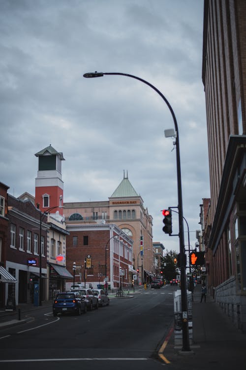 View of a Street and Buildings in a Town under a Cloudy Sky 