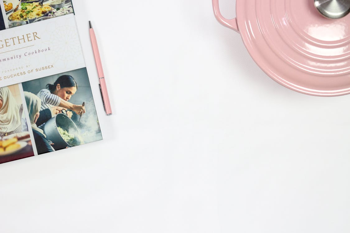 Free Pink Click Pen Near Cooking Pot Stock Photo