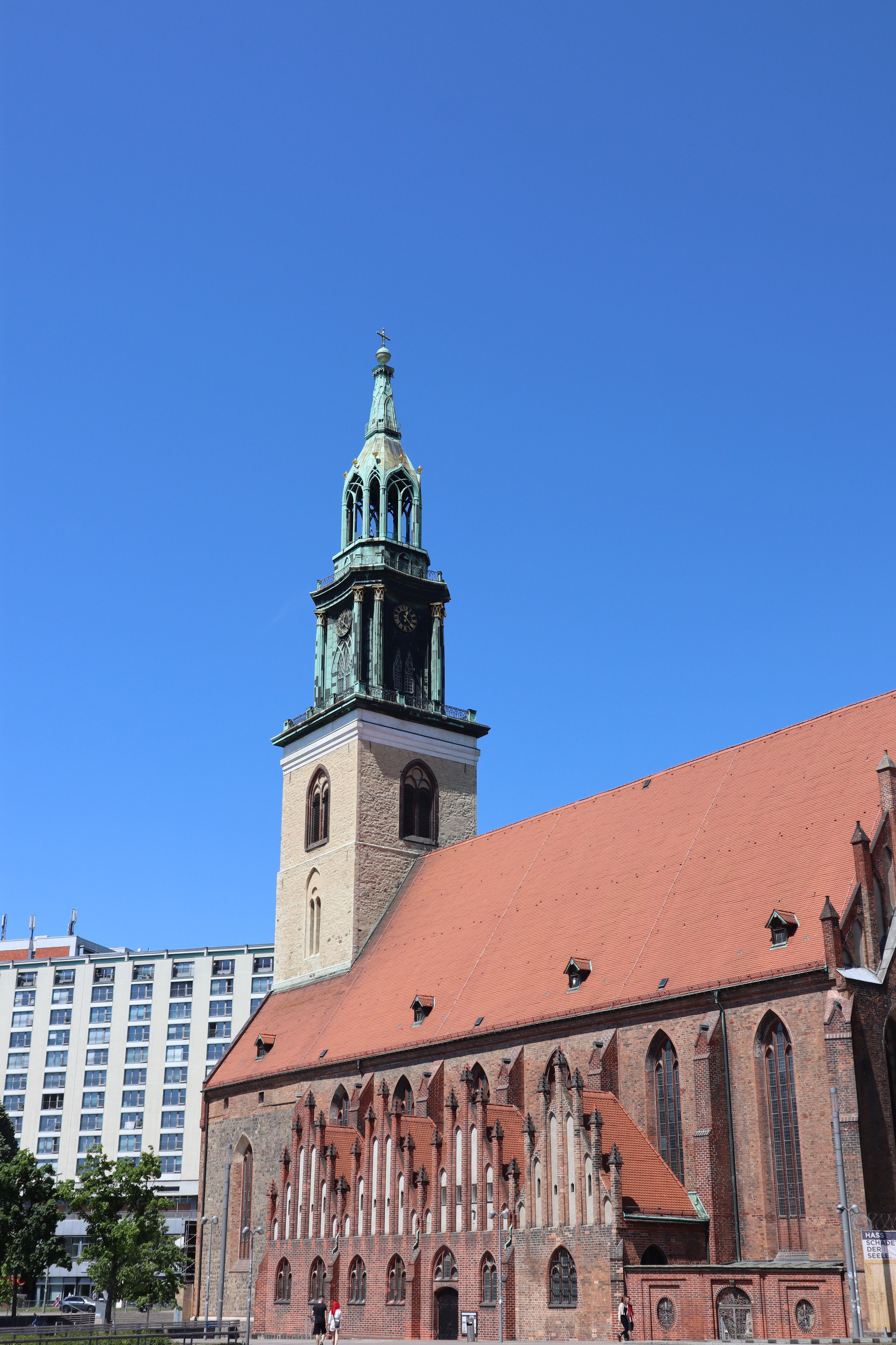 Historic St. Mary's Church in Berlin against a clear blue sky, showcasing Gothic architecture.