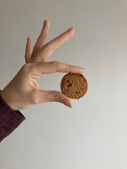 Close-up of Woman Holding a Small Cookie 