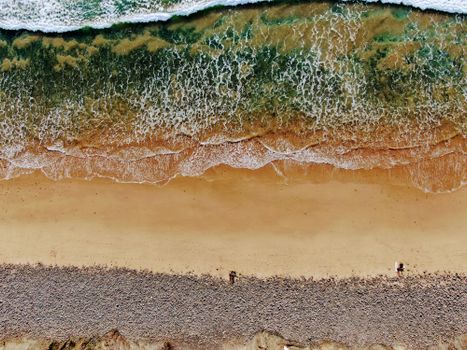 Stunning aerial shot of Aljezur beach, showcasing the meeting of ocean waves and sandy shore.