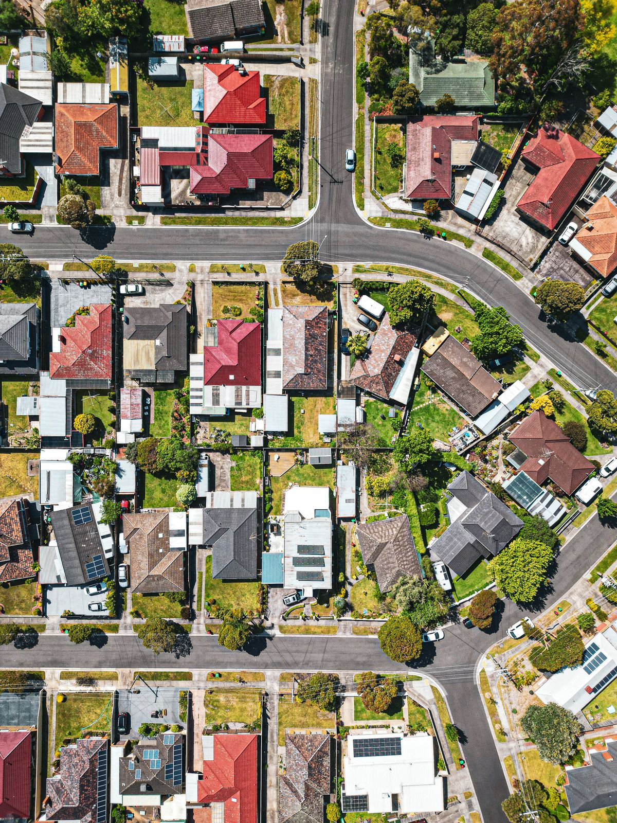 Aerial view of rooftops across an Australian suburb where off market property is sold before listing