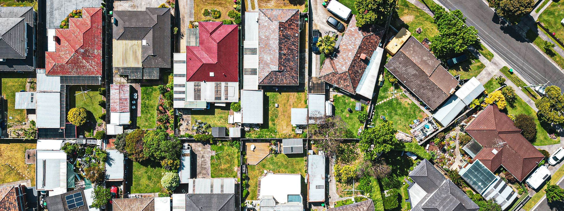 Aerial view of suburban streets and homes with terracotta and Colorbond roofs