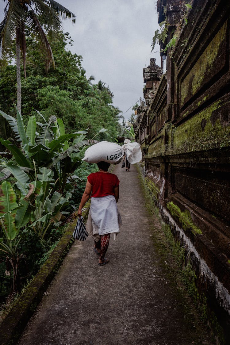 Woman Carrying Heavy Bag On Head