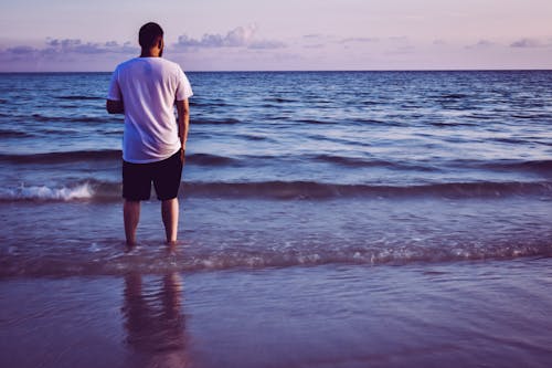 Free Photo of Man Standing On Seashore Stock Photo