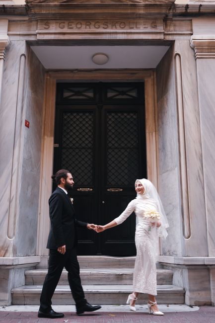 Newlywed couple posing in an urban setting, capturing timeless elegance and romance.