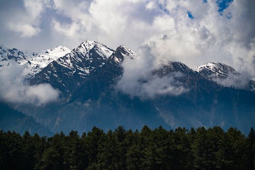 A Mountain with Snow Under the Clouds