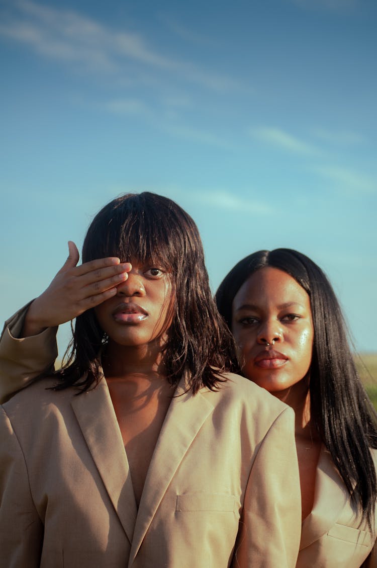 Portrait Of Two Black Women With One Covering With Her Hand The Eye Of The Other