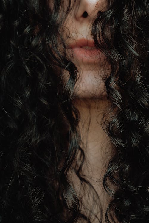 A Close-Up Shot of a Woman with Curly Hair