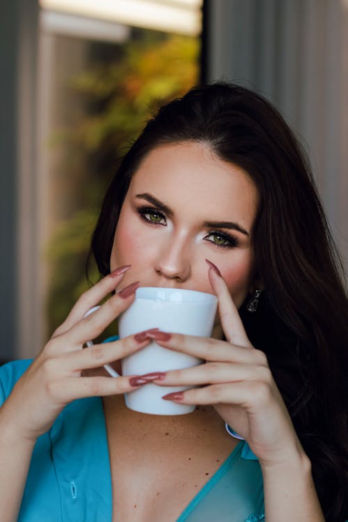A Woman Holding White Ceramic Cup