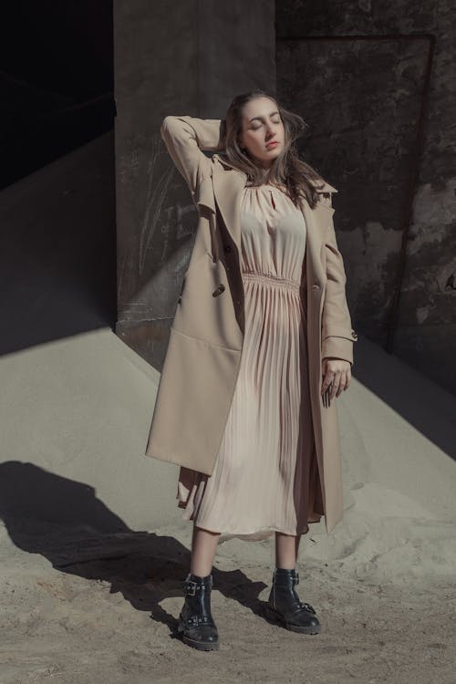 A Fashionable Woman in Brown Dress and Trench Coat
