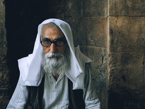 Close-Up Shot of an Elderly Man Wearing Eyeglasses