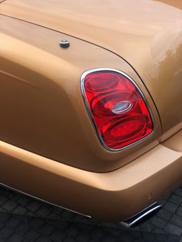 Elegant gold car featuring a striking red taillight accent, Barvikha, Russia.