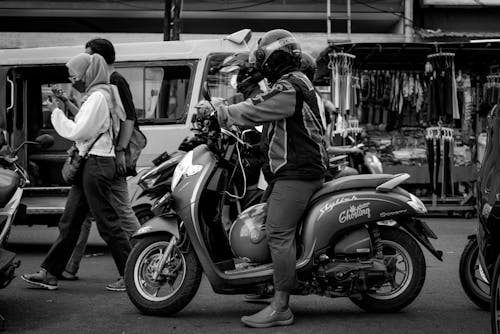 Monochrome Photo of a Person Riding a Motorcycle