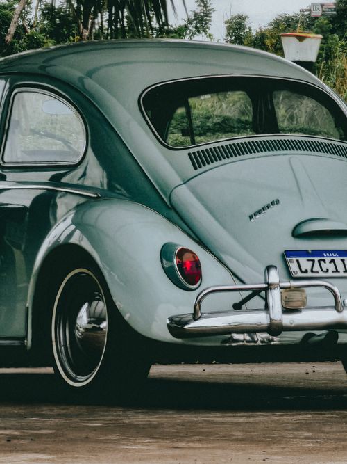Free Close-up of a classic Volkswagen Beetle's back view on a sunny day, showcasing its retro design and charm. Stock Photo