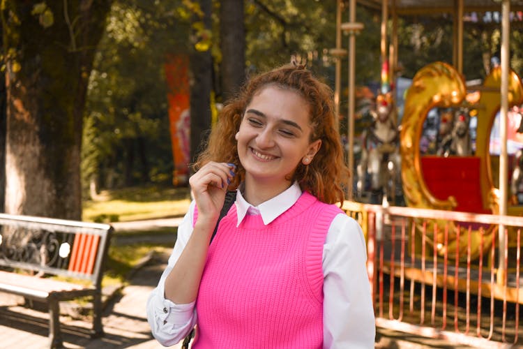 A Smiling Woman In Pink Knitted Vest 