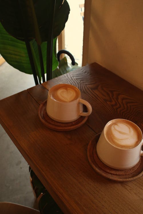 Free Cups of Coffee on a Wooden Table Stock Photo