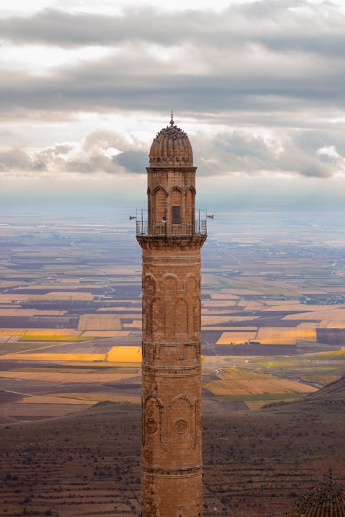 Tall Minaret against Landscape with Fields