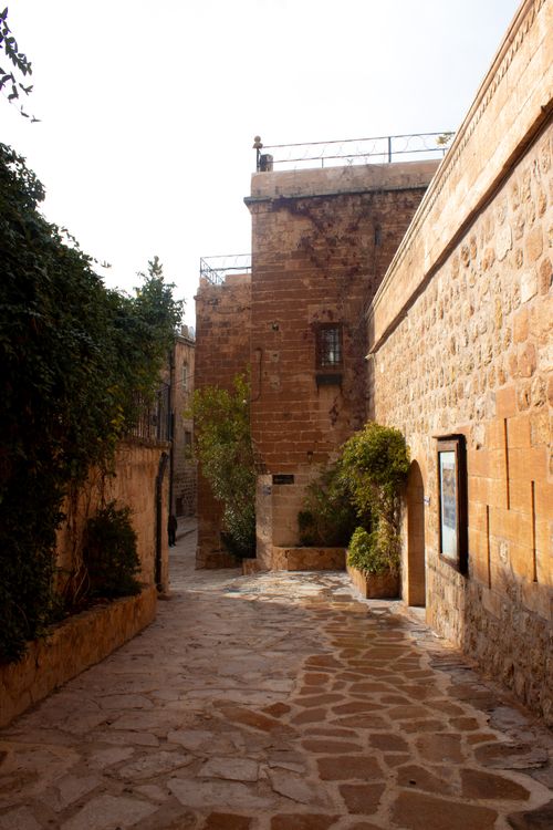 Free Explore the narrow cobblestone streets and ancient stone buildings of Mardin, Turkey's historic city. Stock Photo