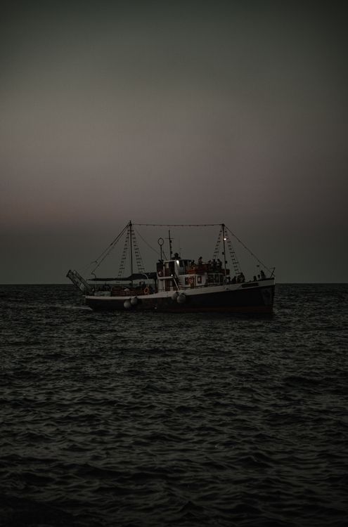 Fishing vessel at sea at dusk