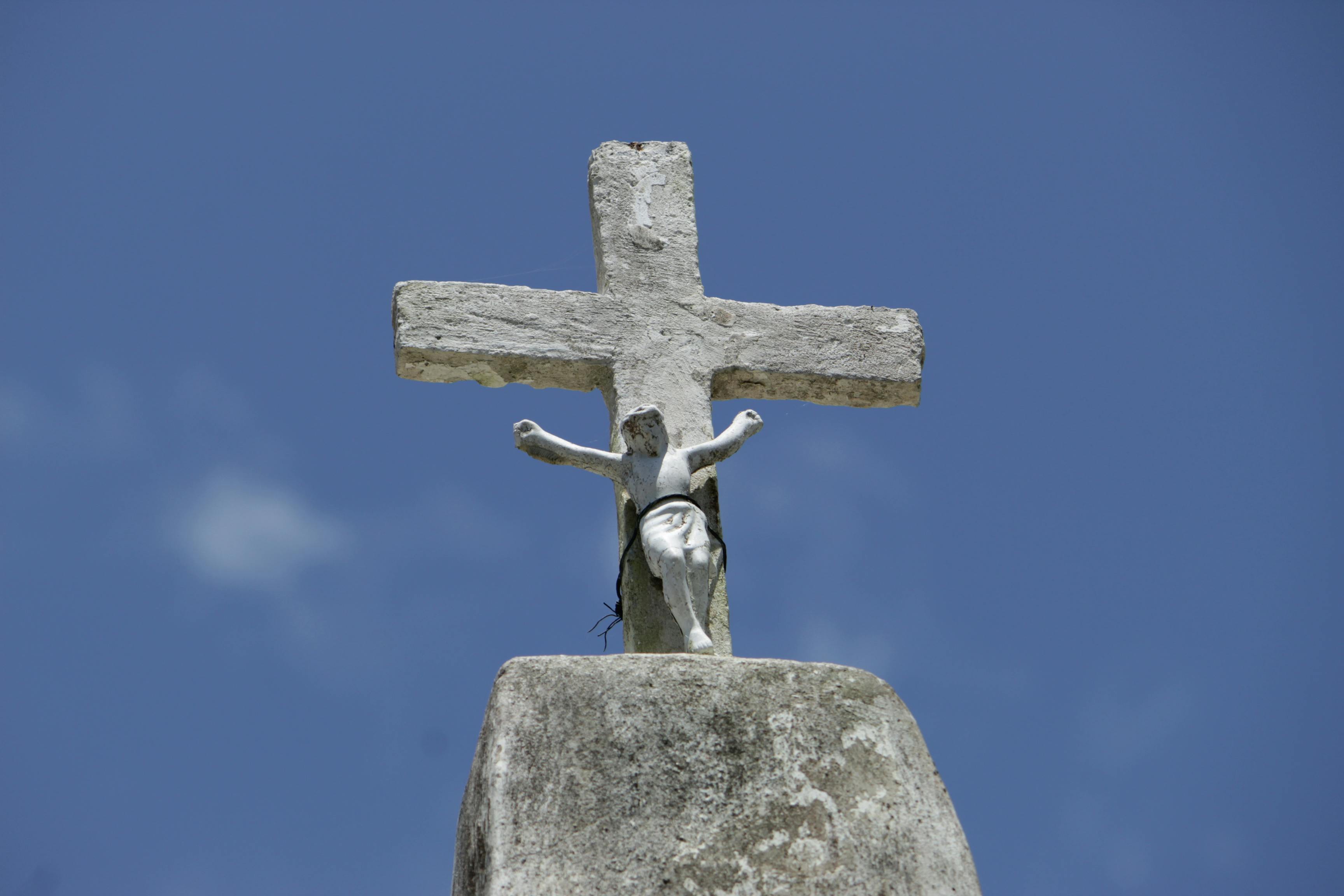 Concrete Statue and a Cross Under a Blue Sky · Free Stock Photo