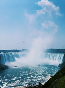 Majestic Niagara Falls captured in bright daylight, showcasing its power and beauty.