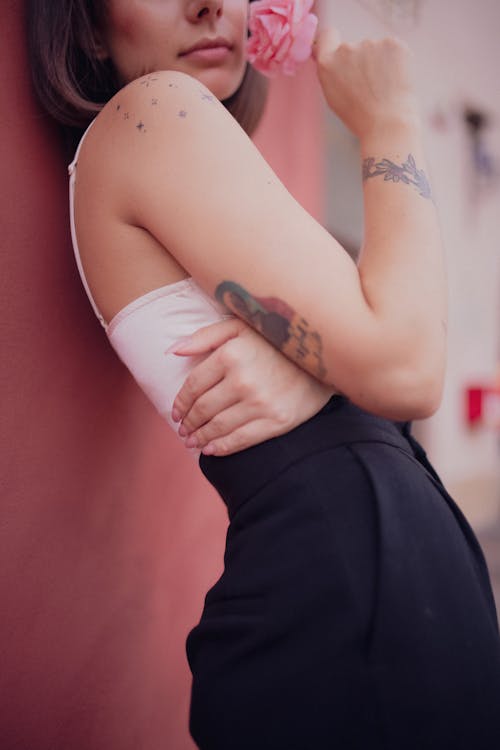 Close Up Photo of Woman Leaning on Wall