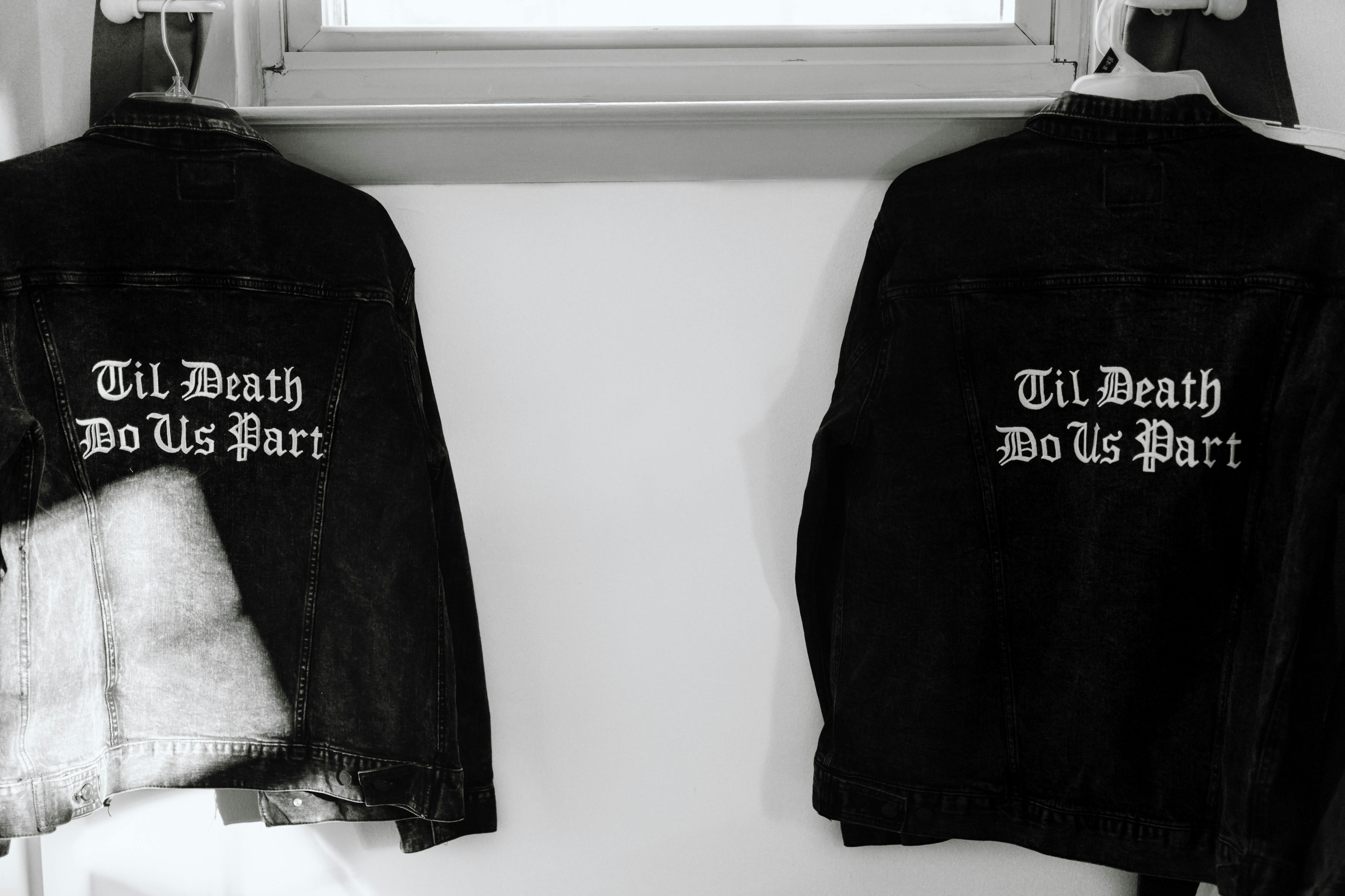 black and white jackets hanging beside white wall