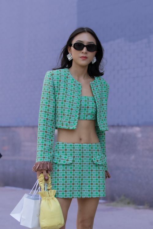A Fashionable Woman Standing and Posing on the Street · Free Stock Photo