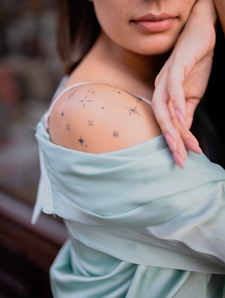 A Woman With Tattoo On Her Shoulder